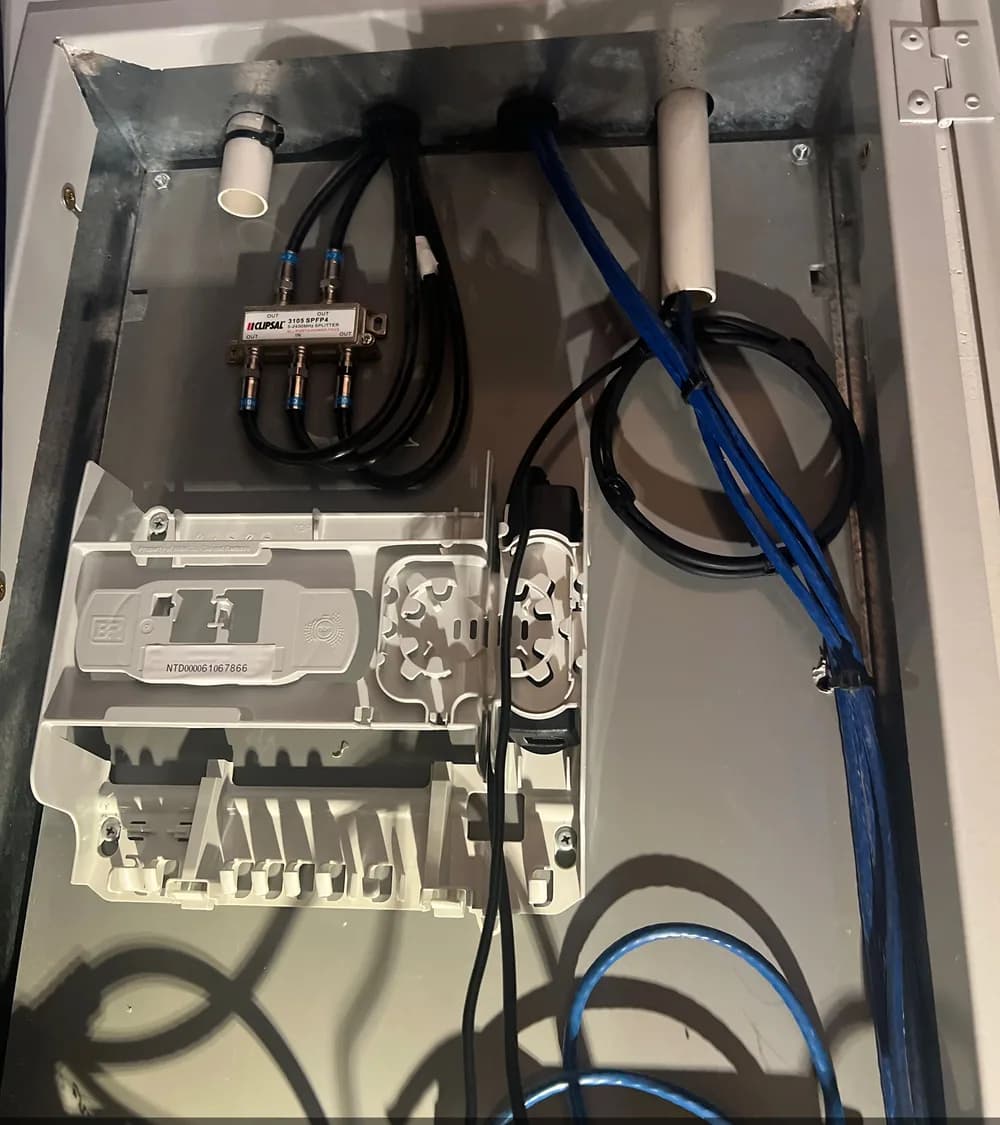 NBN enclosure showing organised fibre and data cable routes