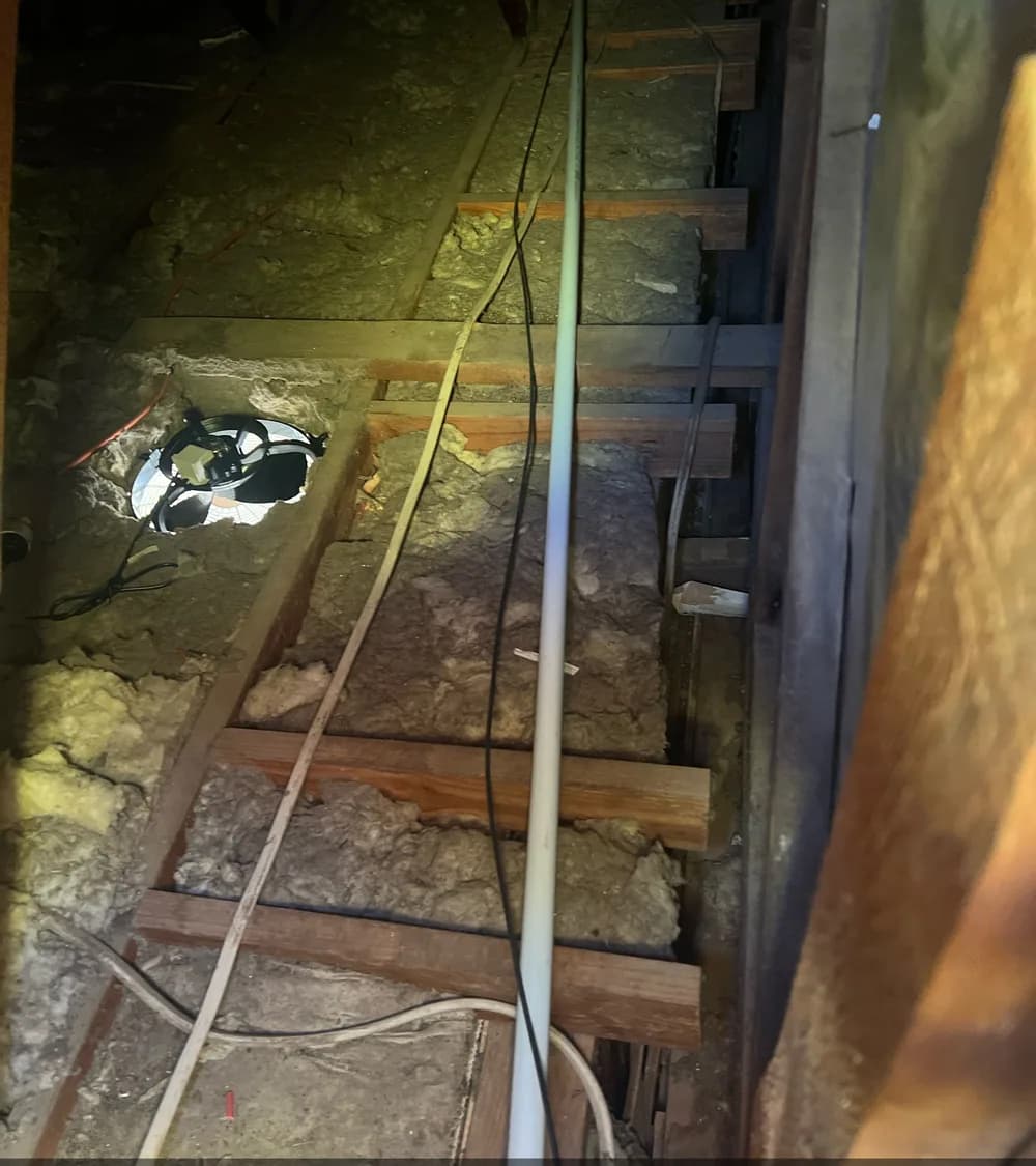 Telecommunications cable routed through a residential roof space